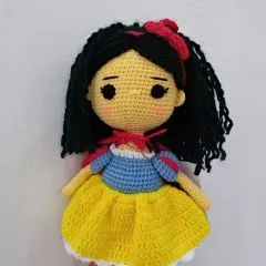 Here is my crochet version of Snow White, complete with her black hair, red bow, and iconic dress. A perfect gift for any Disney fan.
