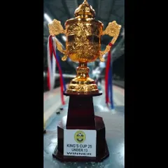 A close-up shot of the gleaming King's Cup U13 Winner's trophy. This trophy symbolizes the hard work, dedication, and success of our young champions.