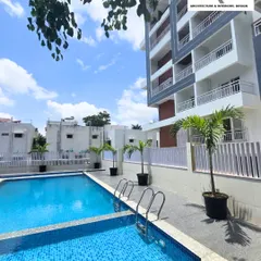 Another angle of the apartment community's pool area, showing how it integrates with the surrounding greenery and building architecture. It's designed to be a refreshing escape for residents.