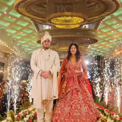 A classic couple entry on a reflective mirror aisle. The cold pyro fountains on either side add a touch of glamour, and I coordinate the timing to make sure the photographers capture the perfect shot.