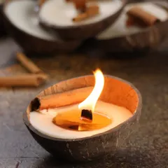 The Cinnamon Coconut candle, lit and glowing. The wooden wick crackles softly, adding to the cozy, nostalgic ambiance. It's perfect for evenings when you want your space to feel like home.
