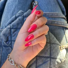 Another shot of this eye-catching magenta manicure. The high-gloss finish and perfect shaping highlight the quality of the service.