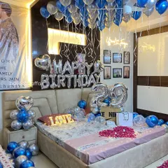 A full view of the blue and silver themed birthday room, showing how all the elements from the floor petals to the ceiling balloons come together.