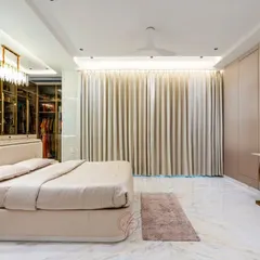 This shot shows the full expanse of the room, including the floor-to-ceiling curtains and the heart-shaped gold console table. It’s a space designed for both rest and sophisticated living.