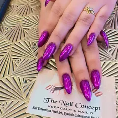 Make a bold statement with these stunning purple chrome nail extensions. The long, almond-shaped nails have a mirror-like finish that catches the light from every angle for a high-impact, futuristic look.