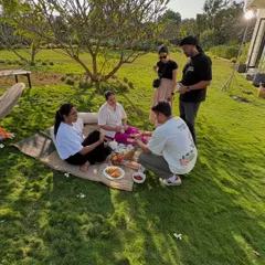 A glimpse of my team setting up for a picnic scene during an outdoor shoot. Collaboration is key, and here we are arranging props and discussing the composition to create a perfect lifestyle moment.