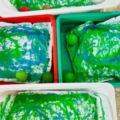 This is our fun marble art painting activity. By rolling marbles dipped in paint inside a box, children create unique patterns, learning about cause and effect while developing their motor skills.