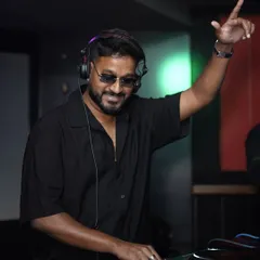 Cueing up the next track with a smile. I genuinely love what I do, and I bring that passion to every performance.