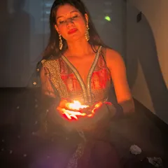 Holding a diya, the light illuminates the rich colors and intricate details of my Diwali outfit. Festive styling is about embracing tradition and celebrating with light and color.