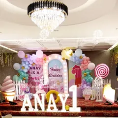 A spectacular Candyland stage for Anay's "Sweet One" birthday. The entire setup is a feast for the eyes, with giant candy props, marquee letters, and pastel balloon arches under an elegant chandelier.