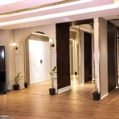 The entrance area of my Ghitorni showroom, featuring a large statement door and an interactive digital display for browsing my extensive catalog.