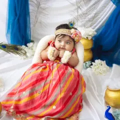 This adorable little Radha is looking so sweet and chubby in her festive outfit. I love creating these culturally rich setups for special occasions.