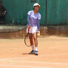 A player prepares to serve, mentally focused for the next point. The mental game is just as important as the physical one.