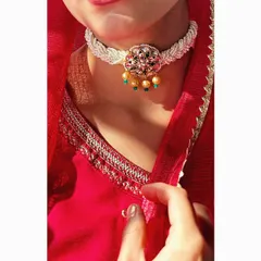A close-up of a delicate, handcrafted kundan and pearl choker. This type of piece is perfect for a Mehendi or Sangeet, adding a touch of royalty without being overpowering.