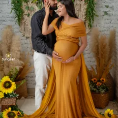 We love capturing the connection between expecting parents. This couple's maternity shoot features our popular boho-chic setup with sunflowers and macrame, creating a warm and intimate portrait.