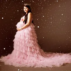 Celebrate your special journey with my maternity photoshoot gowns. This pink ruffled tail gown is perfect for creating those fairy-tale moments you will cherish forever.