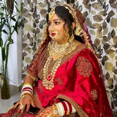 The complete Rajputana bride, adorned in rich velvet and heavy gold jewelry. My makeup is designed to match this grandeur, creating a look of timeless royalty.