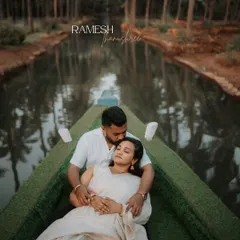 A serene and romantic moment on a traditional boat, surrounded by the iconic palm trees of the backwaters. This shot is perfect for couples wanting a peaceful and picturesque destination shoot.