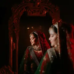 A quiet moment of reflection for the bride, Shikha, before the ceremonies begin. I love using creative lighting and reflections to create artistic bridal portraits that are full of emotion and beauty. This shot feels like a painting, capturing her serene confidence.