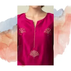 A close-up of a magenta silk kurti featuring a notched neckline and delicate lotus motif embroidery. This kind of subtle detail can elevate a simple kurti into a statement piece.
