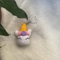 A custom-made unicorn head keychain. The horn is a bright, cheerful yellow, and it has a little flower in its mane. It's a small piece of magic you can carry with you.