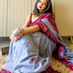 A relaxed, seated pose in the Ikat saree. The cotton fabric is breathable and comfortable, making it a great choice for a long day.