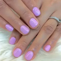 This image showcases a beautiful and clean application of a soft lilac polish on short, natural nails. It's a perfect example of a simple, pretty, and everyday manicure.