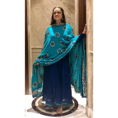 I designed this stunning peacock blue mukaish suit for a client's Mehendi. The traditional craft, combined with a vibrant color and an intricately embroidered dupatta, makes for an unforgettable pre-wedding outfit.
