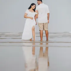 A beautiful shot of Janice and Lyle, where their reflection is captured perfectly in the thin layer of water on the sand. This is a classic example of a romantic beach portrait.