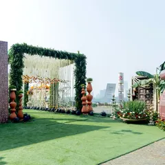 A wider view of the traditional wedding entrance, featuring a grand floral arch, a custom welcome scroll, and sacred elements like banana leaves, all coming together to honor culture and celebration.