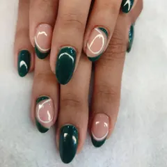 An example of our trendy and artistic nail designs. We used a rich green gel polish and negative space to create a modern, abstract pattern that is both unique and stylish.