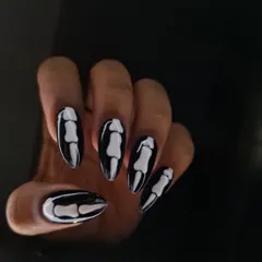 Spooky season is my favorite time to get creative. These Halloween nails feature a glossy black base with hand-painted, 3D-effect skeleton bones on long almond-shaped extensions for a look that's chic and creepy.