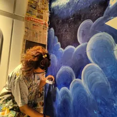 A close-up of me peeling off the masking tape, one of the most satisfying parts of the process. The deep blues of the night sky are really coming together here.