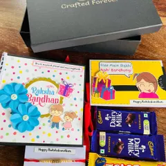Our Raksha Bandhan hamper is more than just a gift; it's a complete celebration in a box. This one features a handmade photo album, a quirky card, a rakhi, and chocolates, all beautifully arranged. It’s the perfect way to tell your sibling they're special.