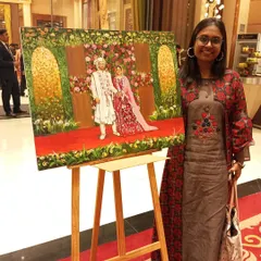 Standing proudly with my completed artwork on its easel at a Delhi wedding. The painting is ready to be presented to the couple as a permanent reminder of their celebration.