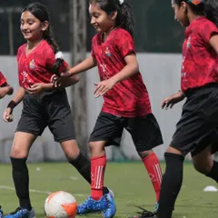 A group of our female players in the middle of an intense training drill, working on their teamwork and ball movement.