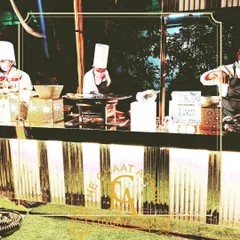 Our luxury setups feature clean lines and warm lighting, creating an inviting atmosphere for guests. This image shows our chefs at their stations, ready to serve the best chaat in Delhi NCR.