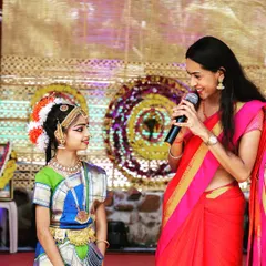 Sharing a moment on stage with a talented young Bharatanatyam dancer. I love creating a comfortable and encouraging atmosphere for performers of all ages at cultural shows and family functions.