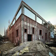 The process of giving an existing building a "surgery" with a new architectural skin. This project involved adding a brick and steel exoskeleton to completely transform the building's appearance and function.