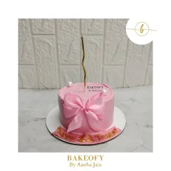 Sometimes, beauty is in simplicity. This minimalist pink truffle cake with a delicate bow is perfect for an elegant celebration.