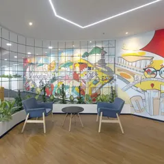 A waiting area at Scientific Games featuring a large, colorful mural that captures the spirit of Bengaluru. The comfortable seating and biophilic elements create a pleasant and engaging space for visitors.