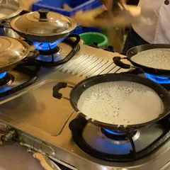A glimpse of our live appam station in action. We bring the authentic taste of South Indian cuisine directly to your event, ensuring every serving is fresh, hot, and made right before your eyes.