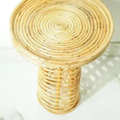 A top-down view of the rattan stool, highlighting the beautiful spiral pattern handcrafted by our artisans. It can be used as a small side table, a stool, or a plant stand.