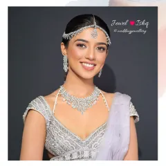 A happy bride-to-be in a modern, all-diamond look. The delicate choker, matching mathapatti, and long earrings are perfect for a chic reception or engagement party.
