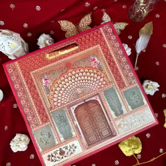 Red is the color of love and new beginnings in our culture. This invitation box captures that emotion with its stunning depiction of a vintage palace 'dwaar' (door), inviting guests to a celebration of heritage and joy.