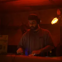 In the zone, crafting a deep and dark minimal set. The focus is on building a locked groove that captivates the audience and keeps them moving for hours.