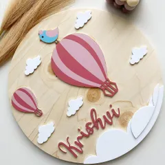 A closer look at the hot air balloon theme, this time in a lovely pink for Krishvi. Each element, including the tiny bird on top, is carefully cut and painted to bring the whole piece to life.