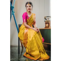 A full-length composition that shows the complete drape of the saree. The vintage props add a touch of nostalgia, ideal for a themed ethnic wear shoot.