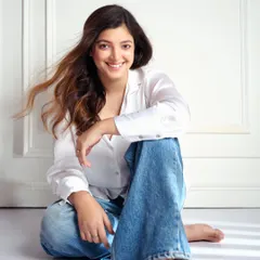 A similar portrait with a more expressive, joyful smile and a hint of motion in the hair. This shows a different side of the model's personality, adding range to her portfolio.