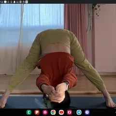 Guiding a student through Prasarita Padottanasana (Wide-Legged Forward Bend) in an online class. Clear instruction and visual feedback ensure you can practice even deep forward bends safely and effectively at home.